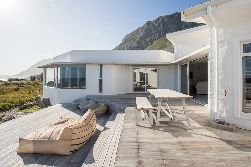 Timber deck with outdoor seating sheltered between the old and new buildings