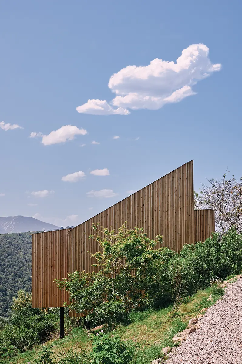 Sloping timber wall on the hillside above the valley