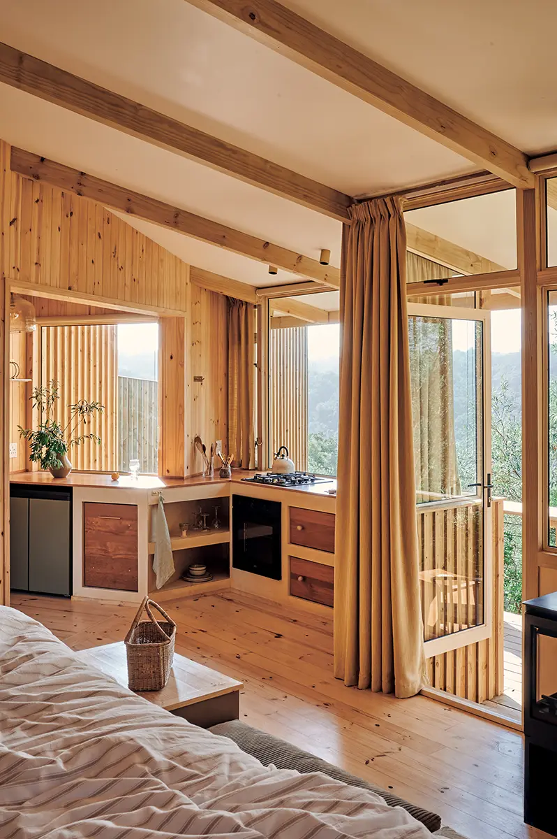 Cabin interior with the kitchenette and full-height windows