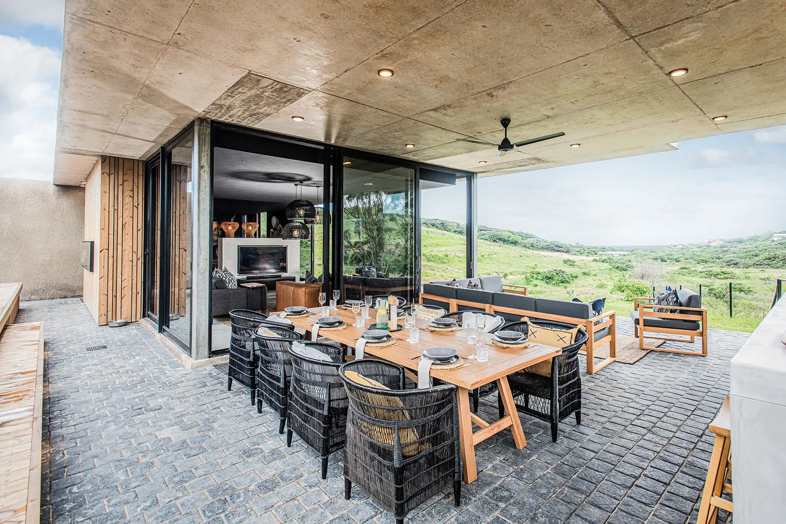 Covered outdoor dining terrace under a concrete roof
