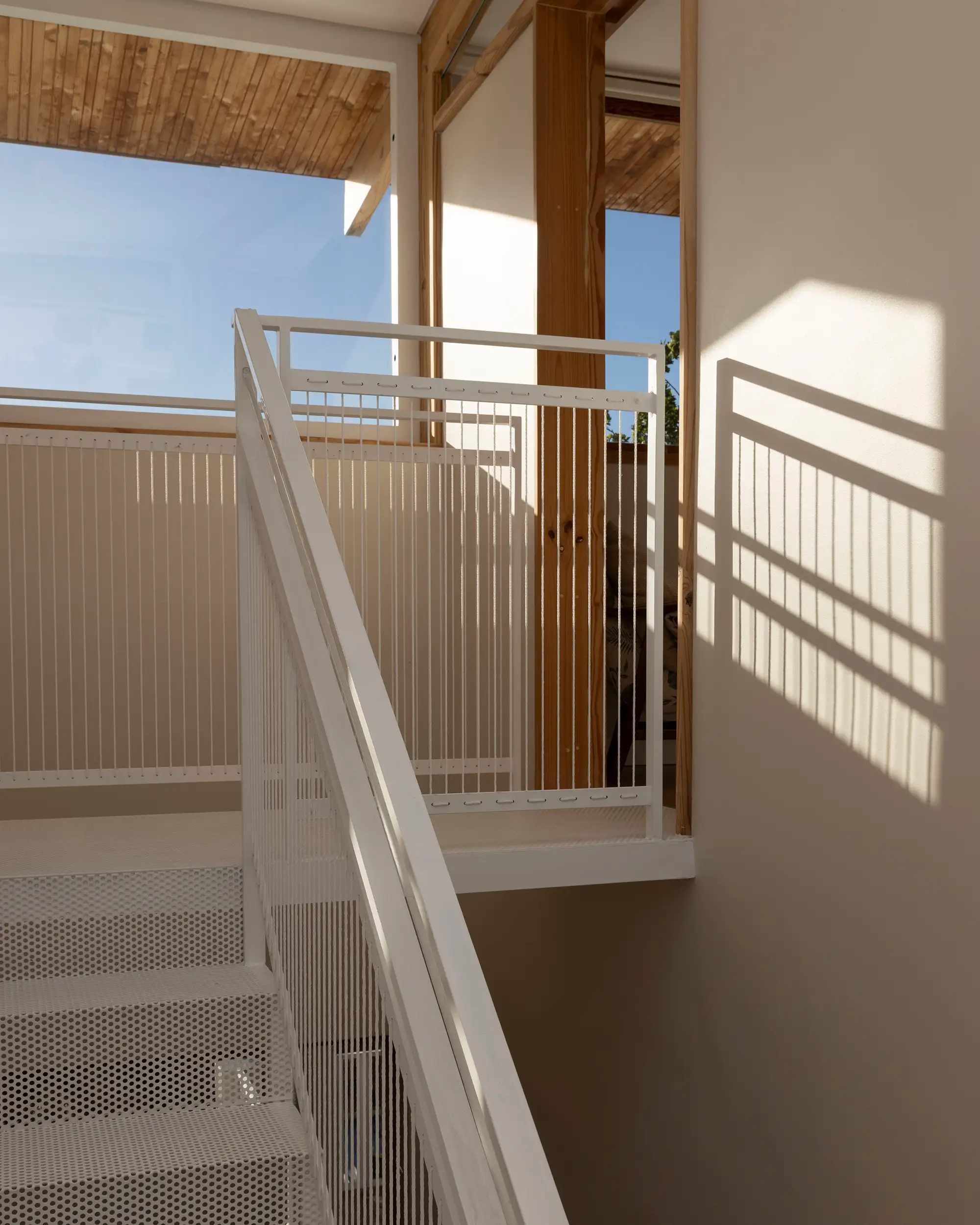Top of the white stair with a timber-framed opening