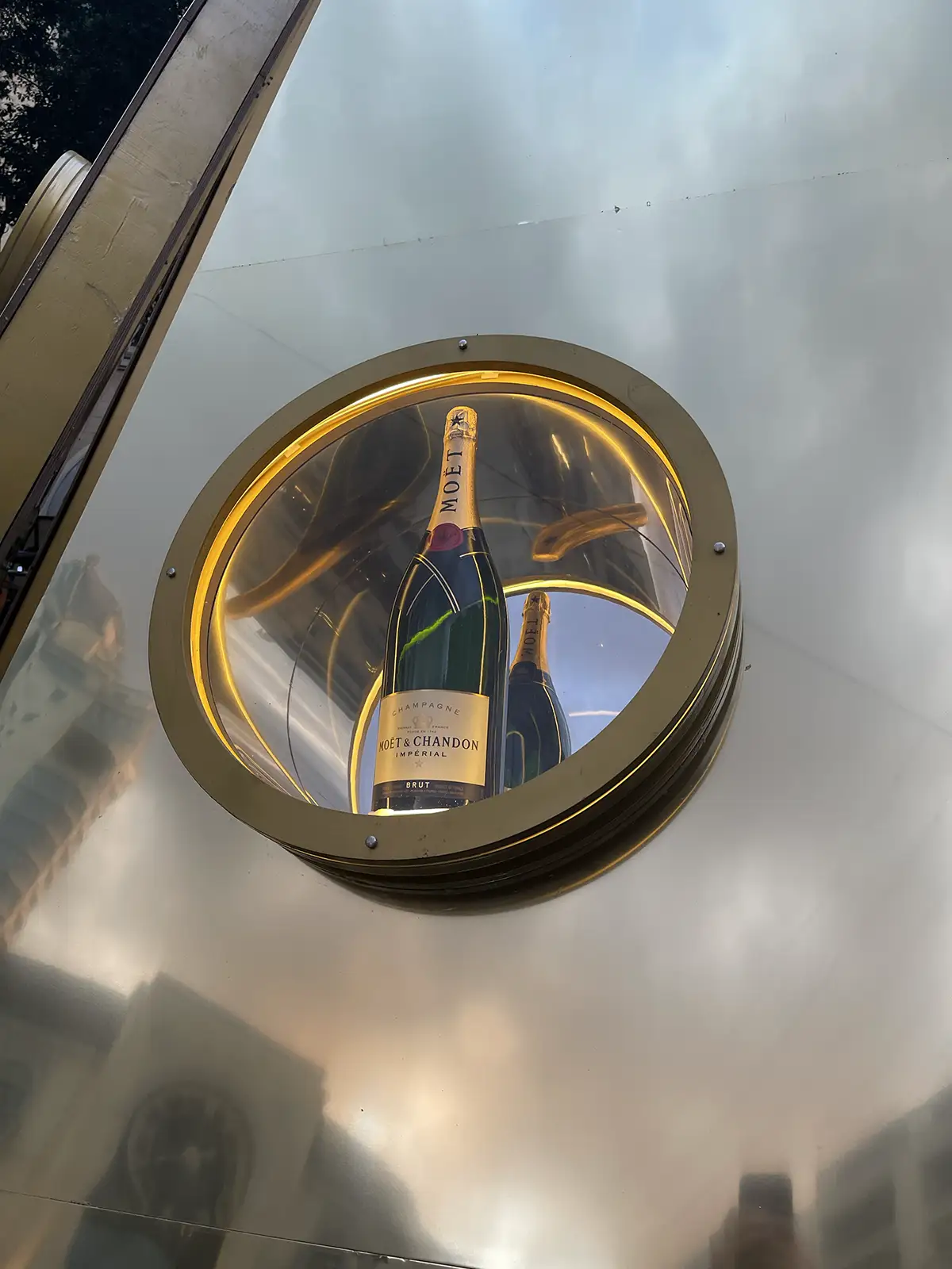 Porthole window with a champagne bottle inside