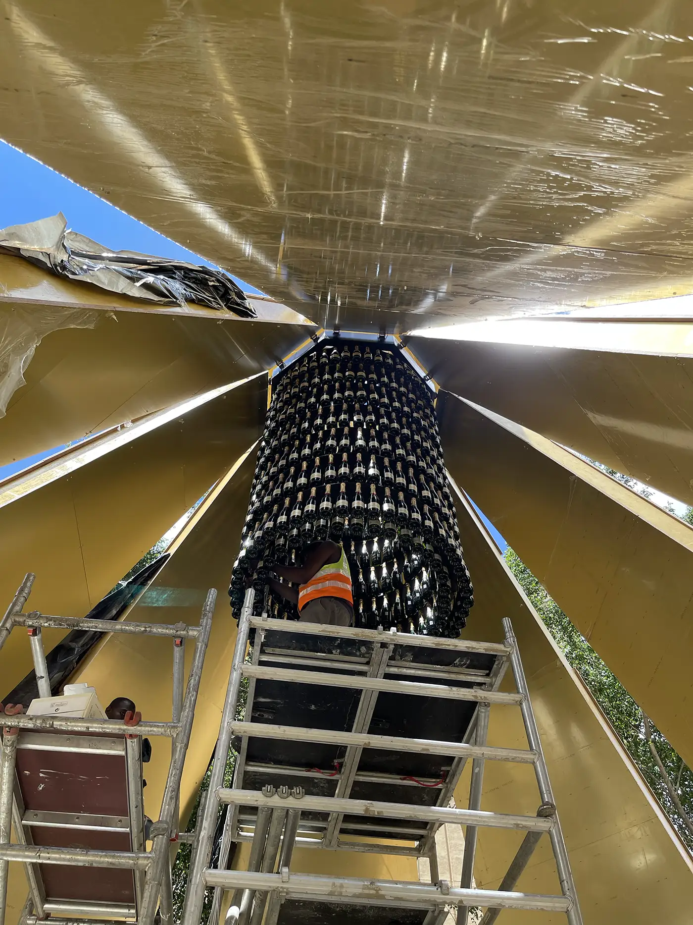 Looking up inside the cone at the tower of bottles