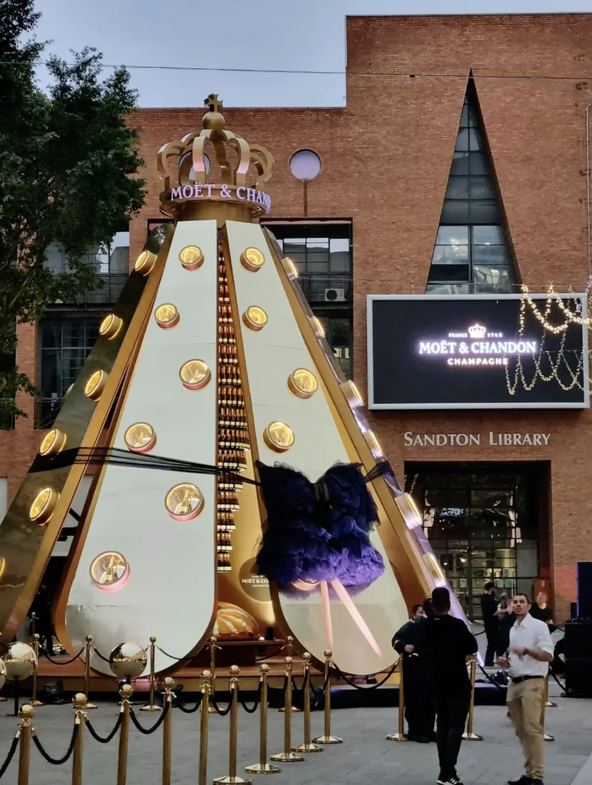 The finished gold cone installation with a crown on top