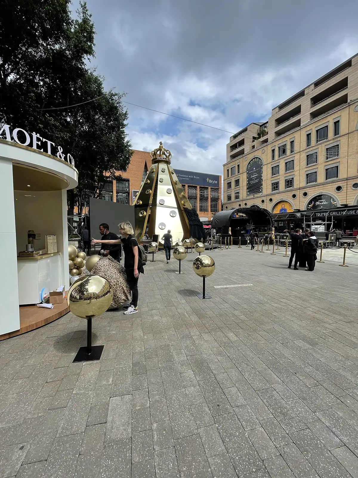 The installation on the square with gold spheres lining the walkway